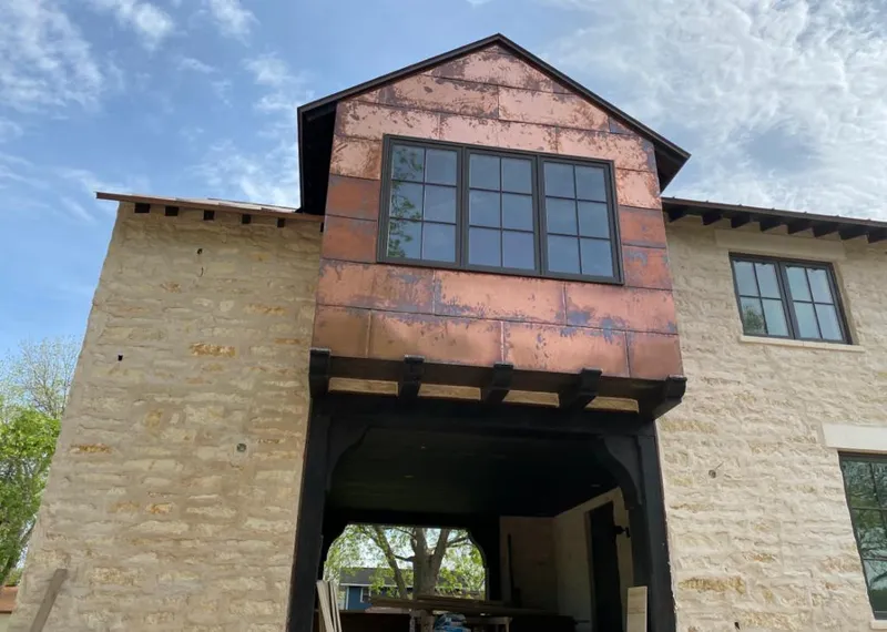 Copper metal panel facade on a stone building for Skylight Installation in Mandeville